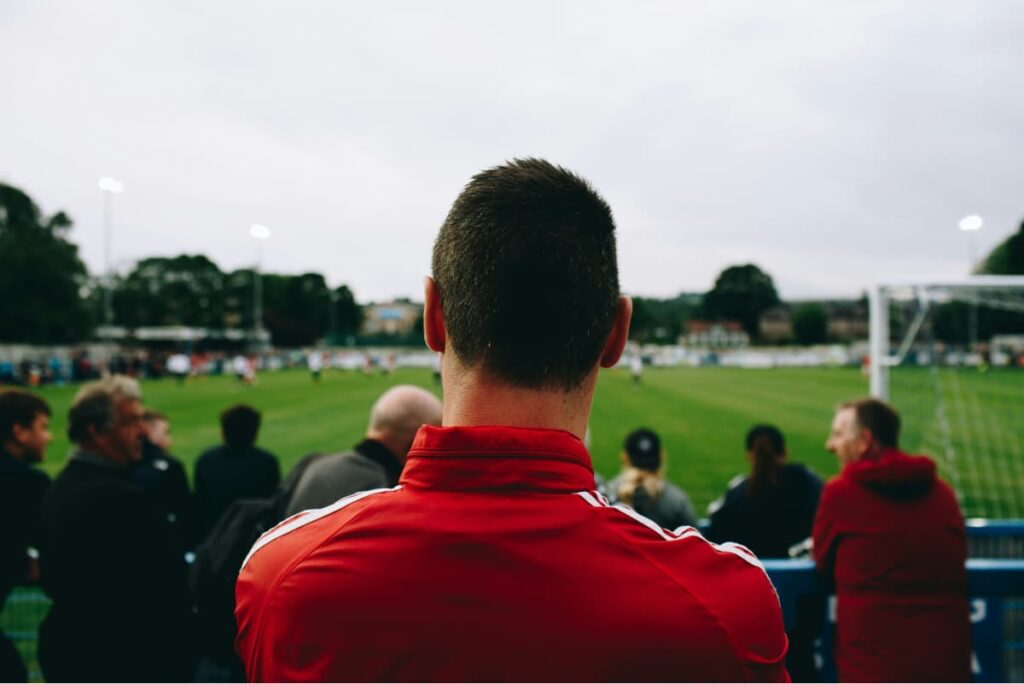 soccer scout in the stands watching a game