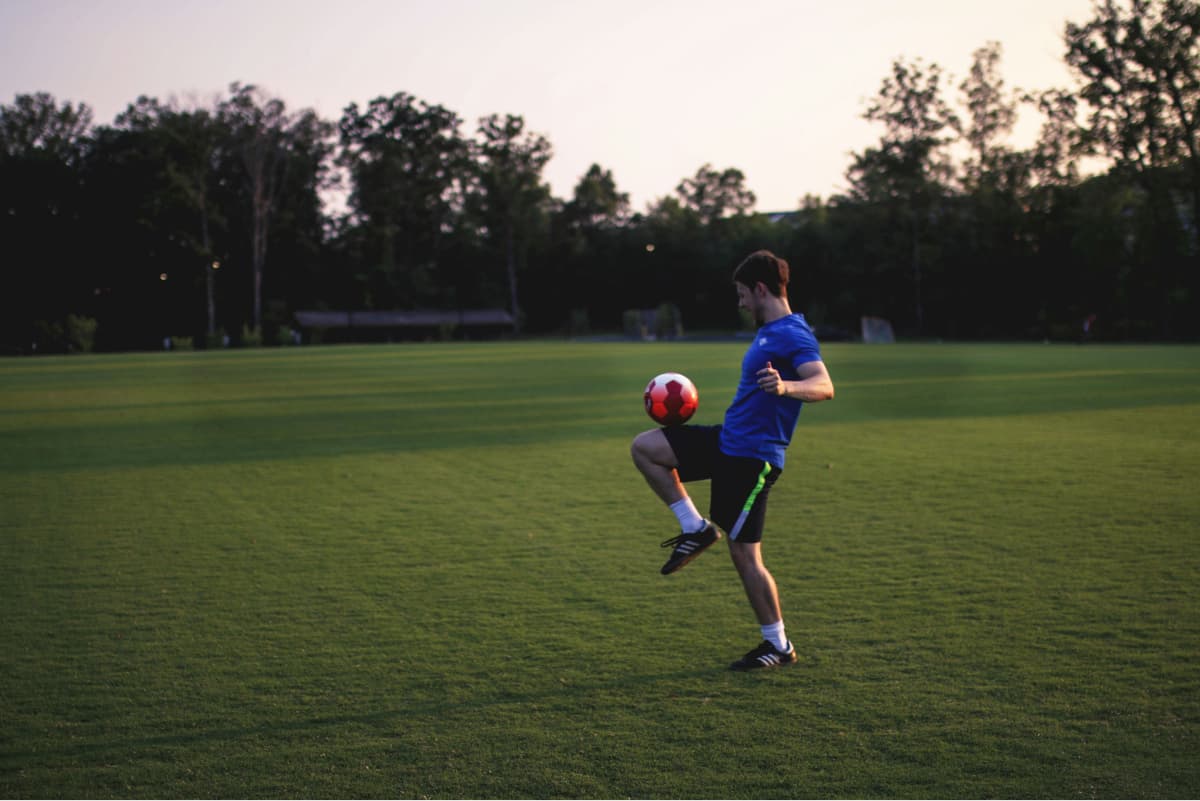 soccer player juggling football
